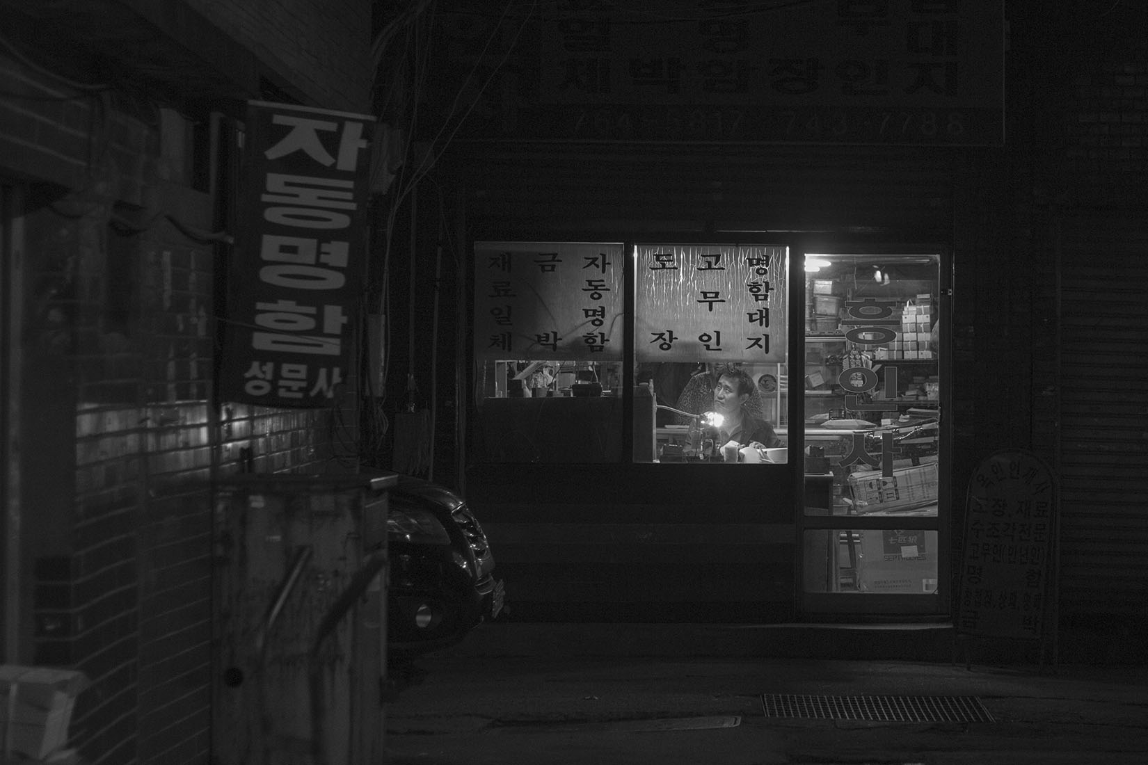 Séoul, atelier dans la nuit, typograhie hangul, homme dans la vitrine